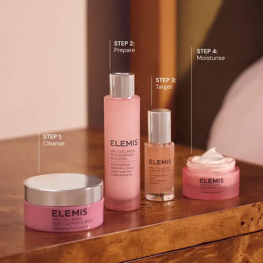 Set of Elemis skincare products on a wooden surface with step indicators.