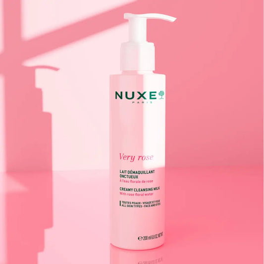 Nuxe Very Rose cleansing milk bottle on a pink background