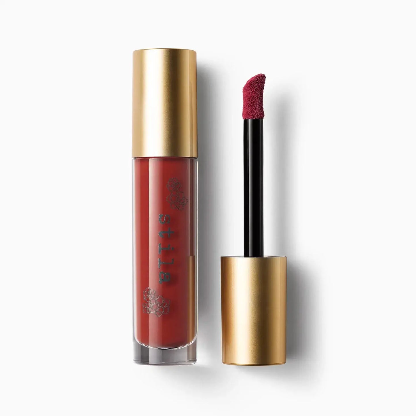 Lipstick with gold casing and red lipstick on a white background