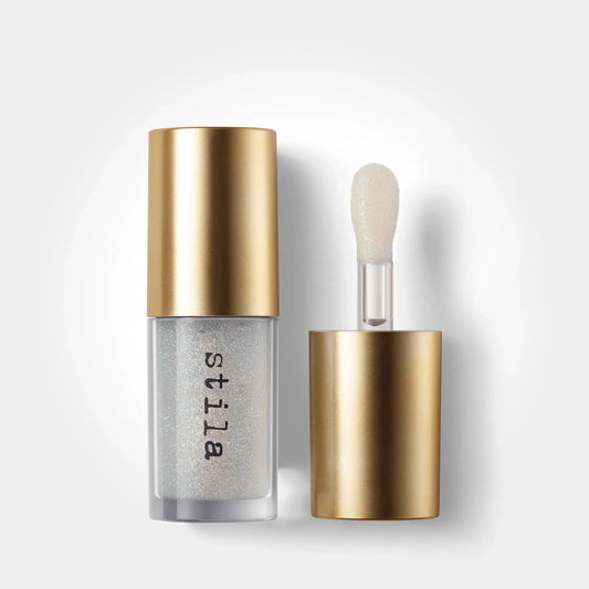 Stila cosmetic bottle with gold cap and silver body on a white background