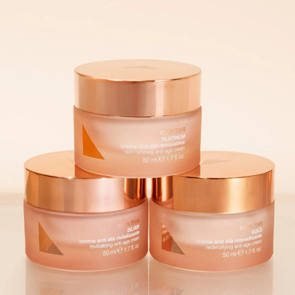 Three skincare jars stacked on a beige background