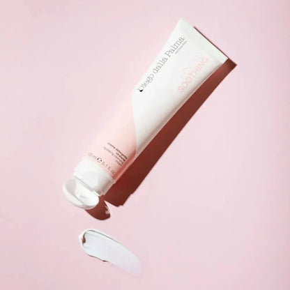 White skincare tube with pink gradient on a light pink background