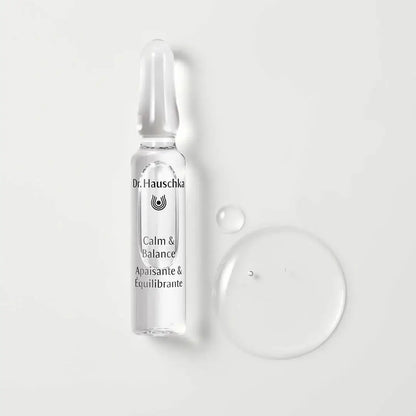 Dr. Hauschka skincare serum bottle with droplet on a light gray background