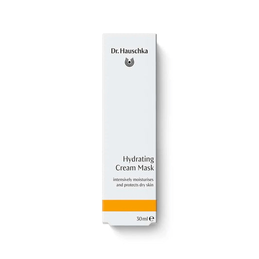 A tall, narrow white box for Dr. Hauschka Hydrating Cream Mask, featuring black text and a bright orange stripe near the bottom, set against a plain white background with a soft shadow.
