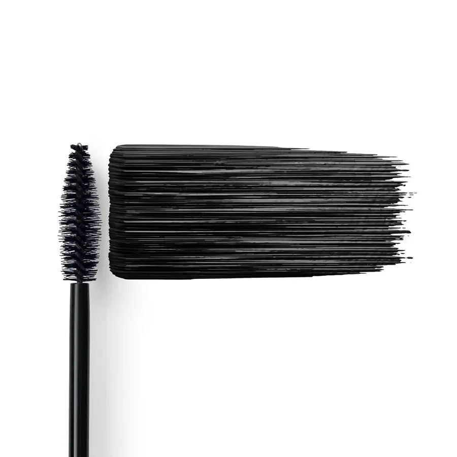 Close-up of a mascara wand with black bristles on a white background