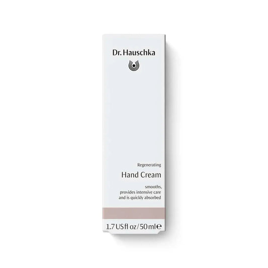 A tall, narrow white box for Dr. Hauschka Regenerating Hand Cream, featuring black text and a small black logo, with a light taupe band near the bottom, set against a clean white background.