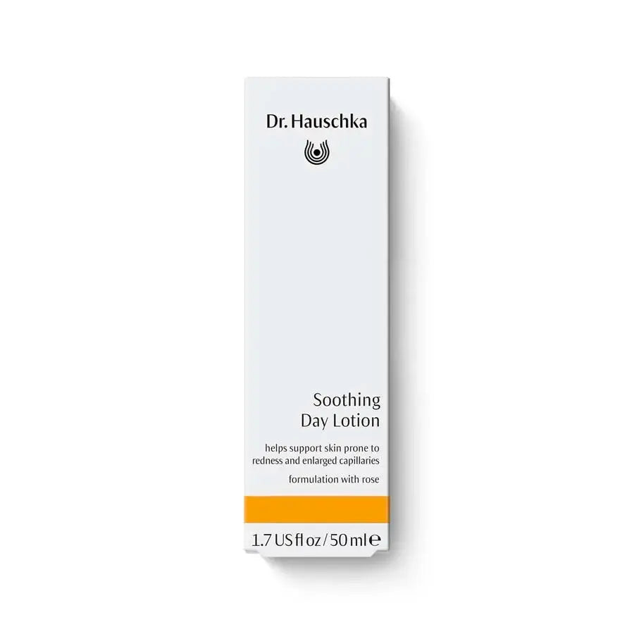 A tall, narrow white box of Dr. Hauschka Soothing Day Lotion with black text and a bright orange band near the bottom, shown on a clean white background.