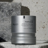 Load image into Gallery viewer, Silver skincare container labeled &#39;Skin Perfusion&#39; by Fillmed on a stone surface.
