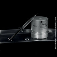 Load image into Gallery viewer, Silver skincare container with syringe on a black tray, featuring the brand &#39;FILLMED&#39;.
