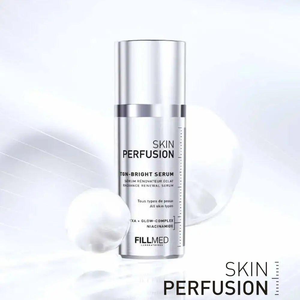 A silver cylindrical cosmetic serum bottle labeled 'SKIN PERFUSION TM-BRIGHT SERUM' by FILLMED, shown on a clean white background with soft blurred spheres and the product name repeated in the lower right.