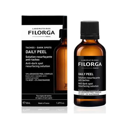 Laboratoires Filorga Daily Peel anti-dark spot resurfacing solution shown in an amber glass bottle with a black cap next to its black and white retail box.