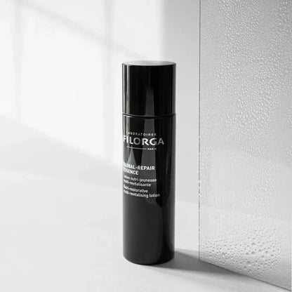 Black skincare bottle with visible branding on a light background