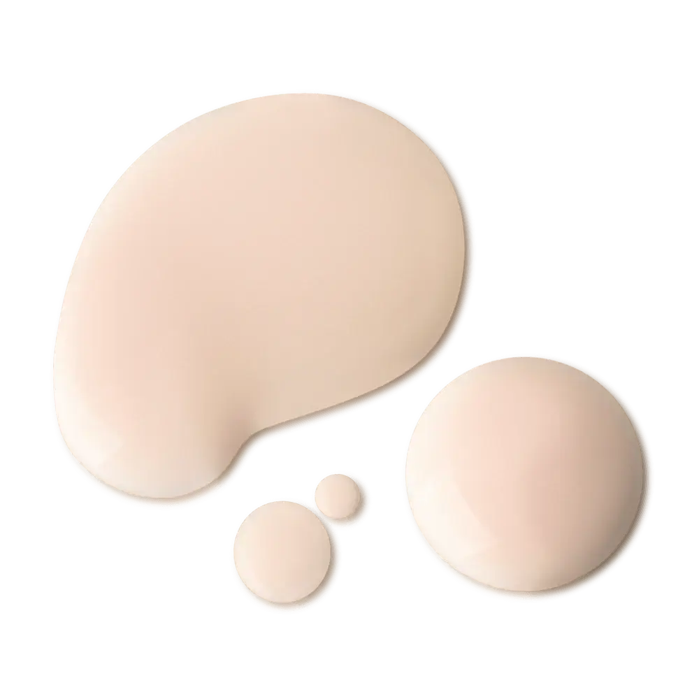 Three smooth, glossy droplets of a light beige cosmetic liquid or cream in varying sizes on a solid white background.