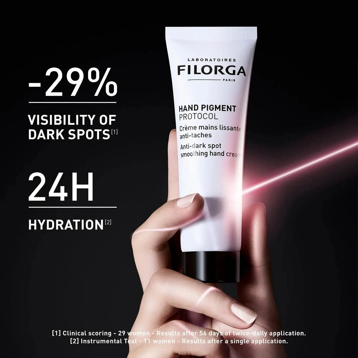 Filorga hand cream tube held by a hand with dark background