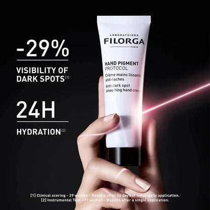 Filorga hand cream tube held by a hand with dark background