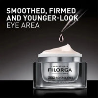 Load image into Gallery viewer, Filorga eye cream jar with dropper on a dark background
