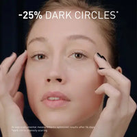 Load image into Gallery viewer, Person applying eye makeup with text indicating dark circle reduction.
