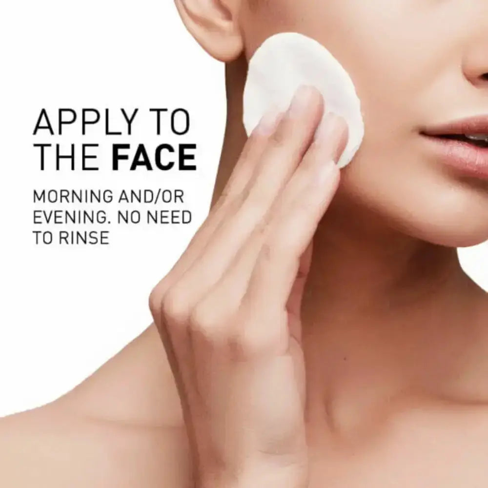 Person applying a product to their face with a cotton pad, on a white background.