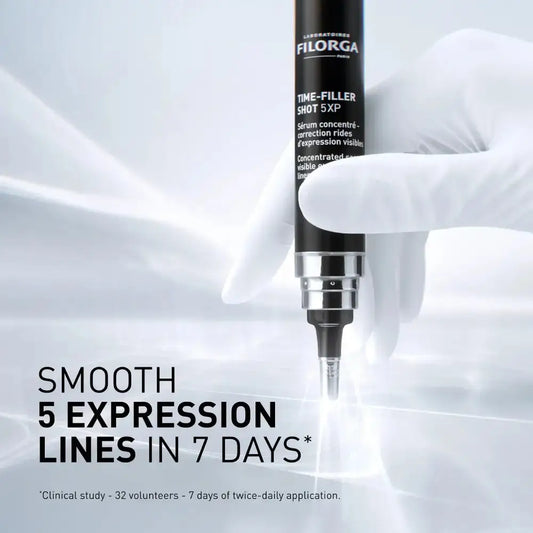 A gloved hand holds a Filorga Time-Filler Shot 5XP cosmetic pen against a bright white background with soft light streaks. Large text reads 'SMOOTH 5 EXPRESSION LINES IN 7 DAYS'.