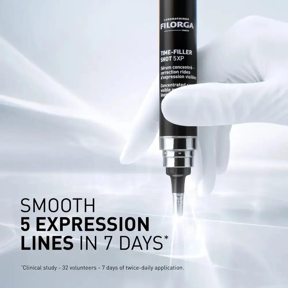A gloved hand holds a Filorga Time-Filler Shot 5XP cosmetic pen against a bright white background with soft light streaks. Large text reads 'SMOOTH 5 EXPRESSION LINES IN 7 DAYS'.