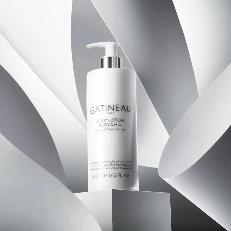 A white pump bottle of Gatineau Paris Body Lotion with Amla, displayed on a geometric white and gray abstract background.