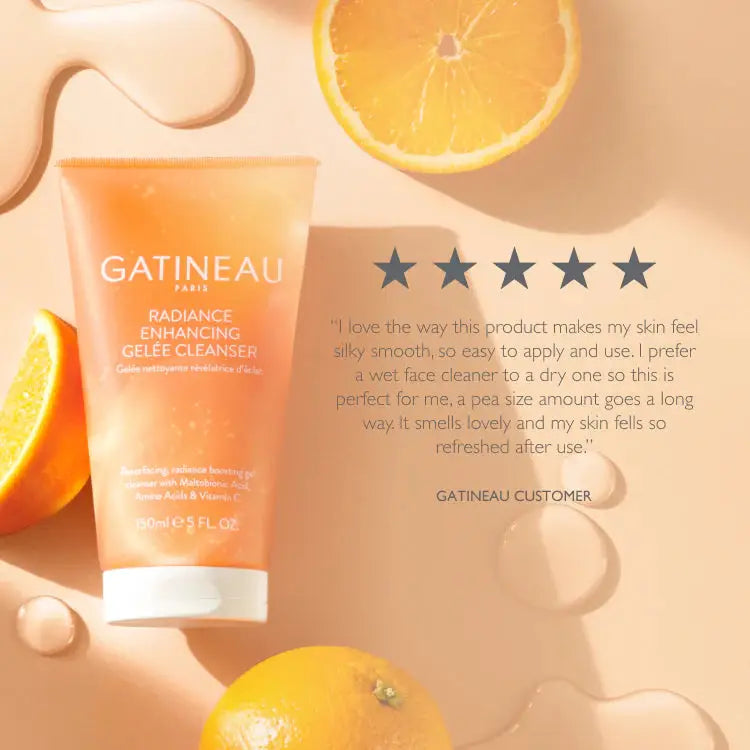Gatineau Paris Radiance Enhancing Gelé Cleanser tube in a peachy-orange color, styled with oranges, liquid droplets, and a customer review on a warm beige background.