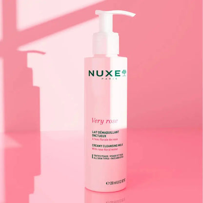 Nuxe Very Rose cleansing milk bottle on a pink background