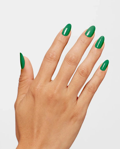 Hand with green nail polish on a light gray background