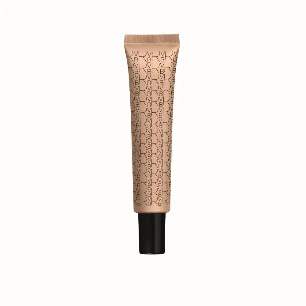 A single tube of NYX makeup foundation in a warm beige shade, featuring a repeating black NYX logo pattern on the tube and a solid black cap, centered against a plain white background.