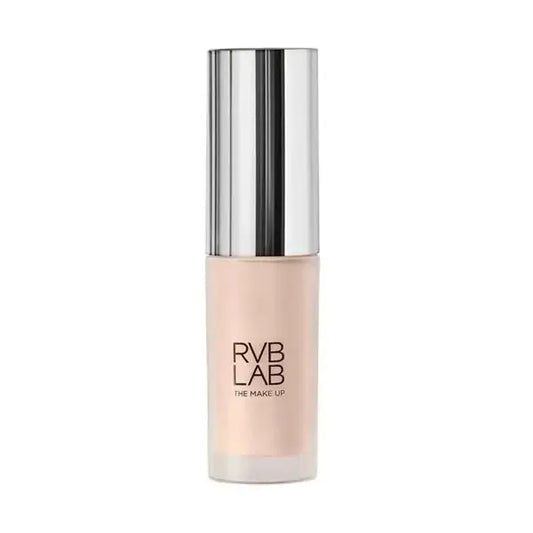 A bottle of RVB LAB The Make Up liquid foundation in a light peach-beige shade, featuring a reflective silver metallic cap on a solid white background.