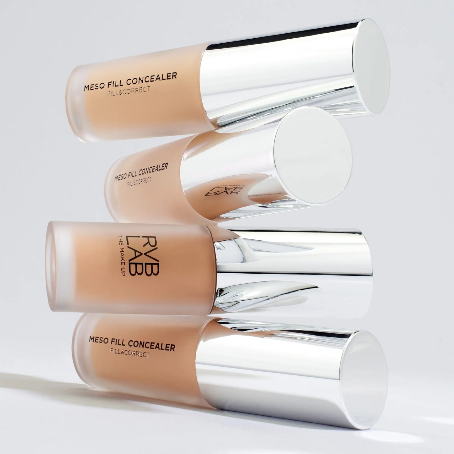 Three Meso Fill Concealer bottles from RVB LAB on a light gray background