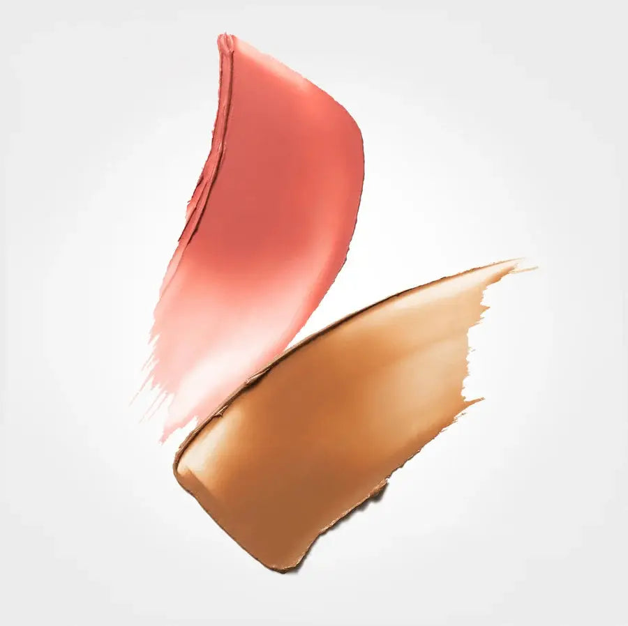 Two makeup swatches on a light gray background: a coral pink swipe above and a warm tan-brown swipe below.