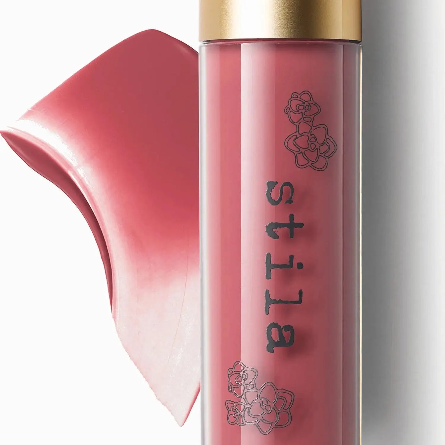 Stila lip gloss with a gold cap on a white background