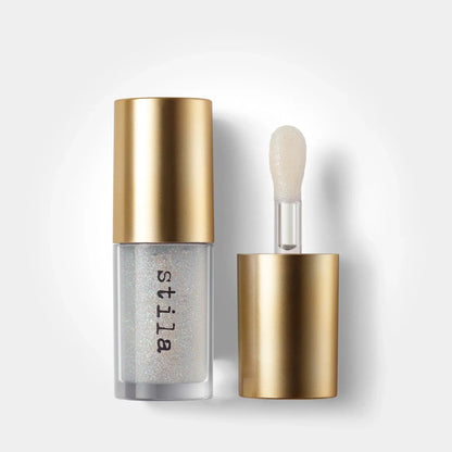 Stila cosmetic bottle with gold cap and silver body on a white background