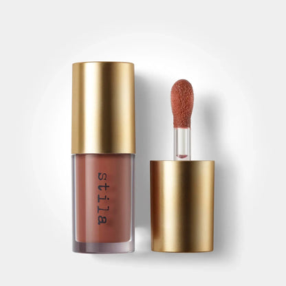 Stila lip gloss with applicator on a white background