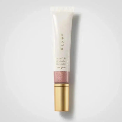 Lip balm tube with gold cap on a light gray background