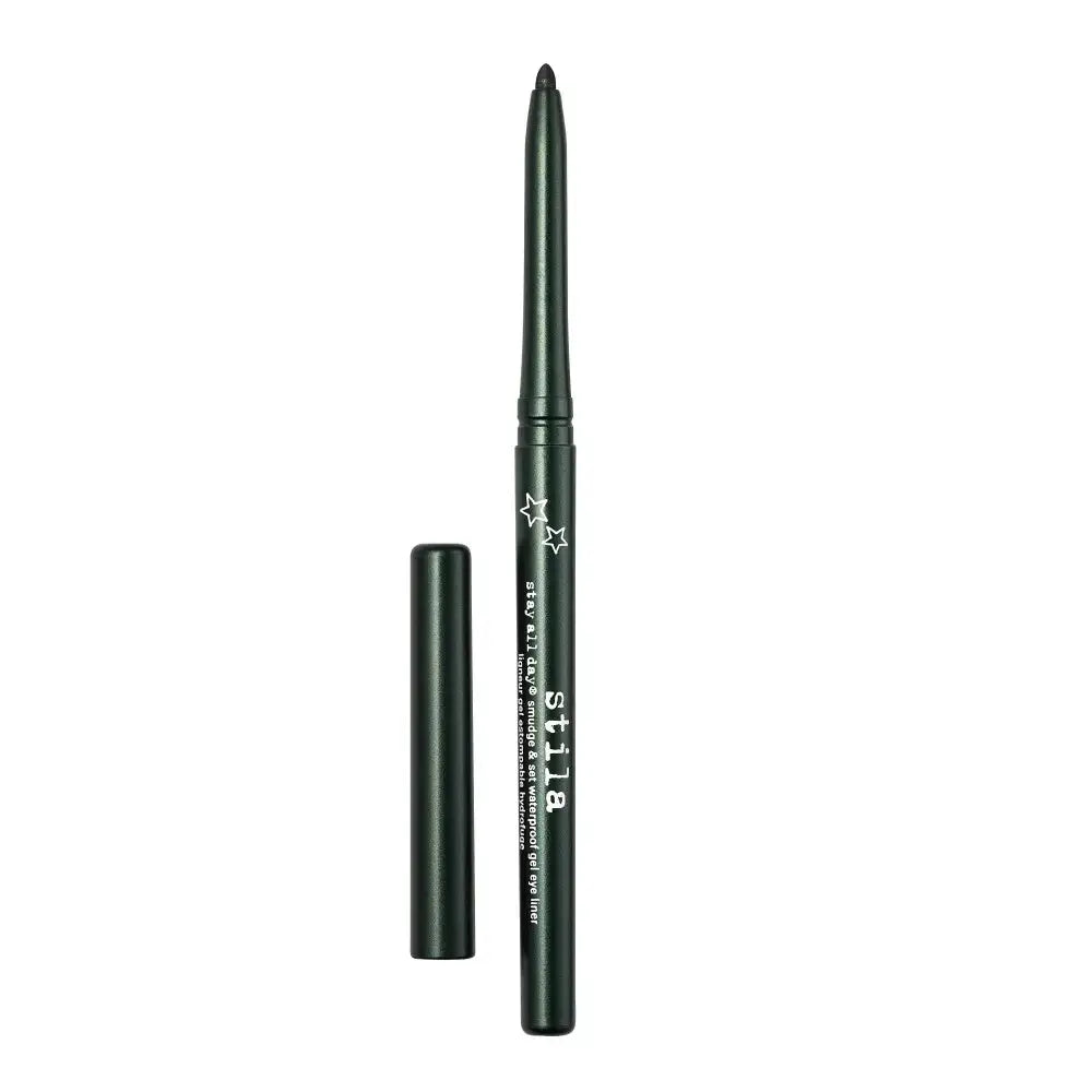 A dark green eyeliner pencil with its cap removed, standing vertically next to it on a plain white background. The brand name 'stila' is printed in white on the barrel of the pencil.