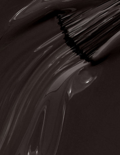 Close-up of a brush with black bristles on a dark background